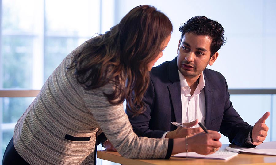 Business student looking up at presentation in front of class