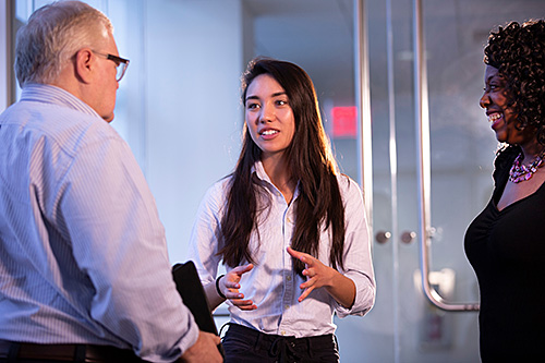 student pitching an idea to two professors