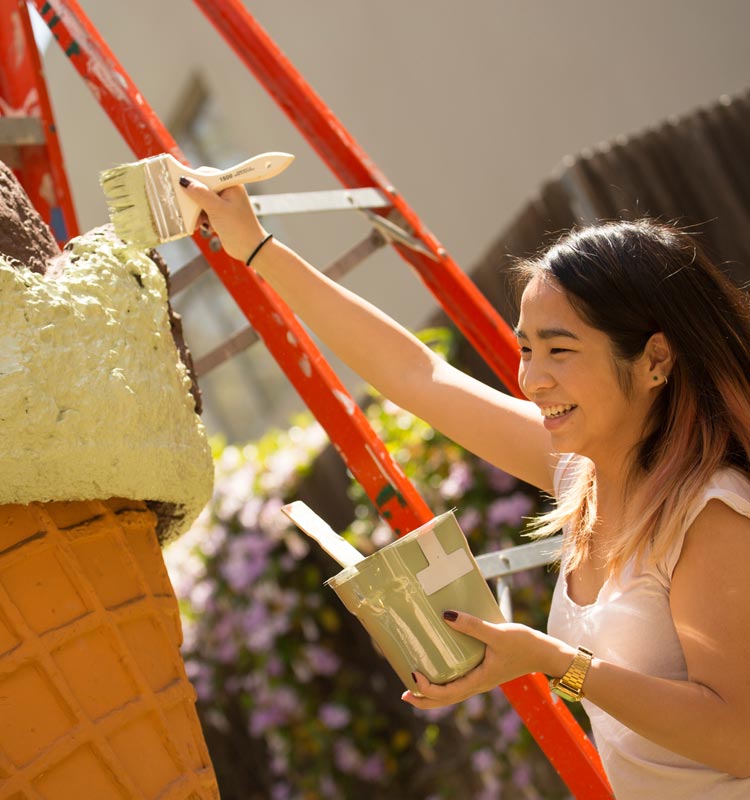 art student painting a sculpture