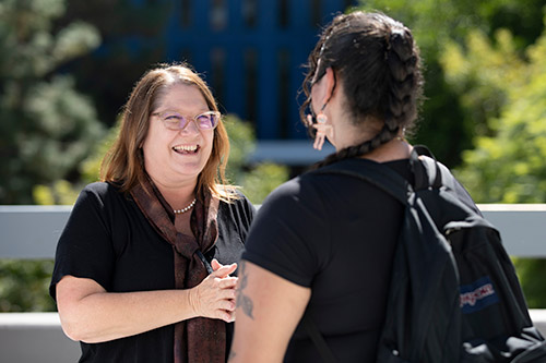A professor conversing with a student